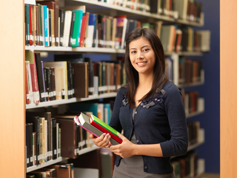 Young college-age student in a campus library