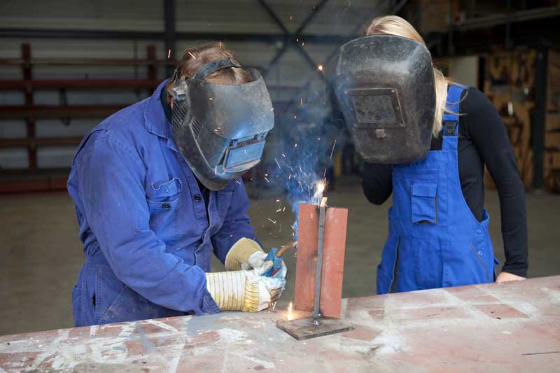 Students in a vocational education program learn to weld