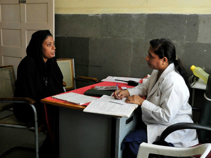 A gynecologist in India consults with a female patient