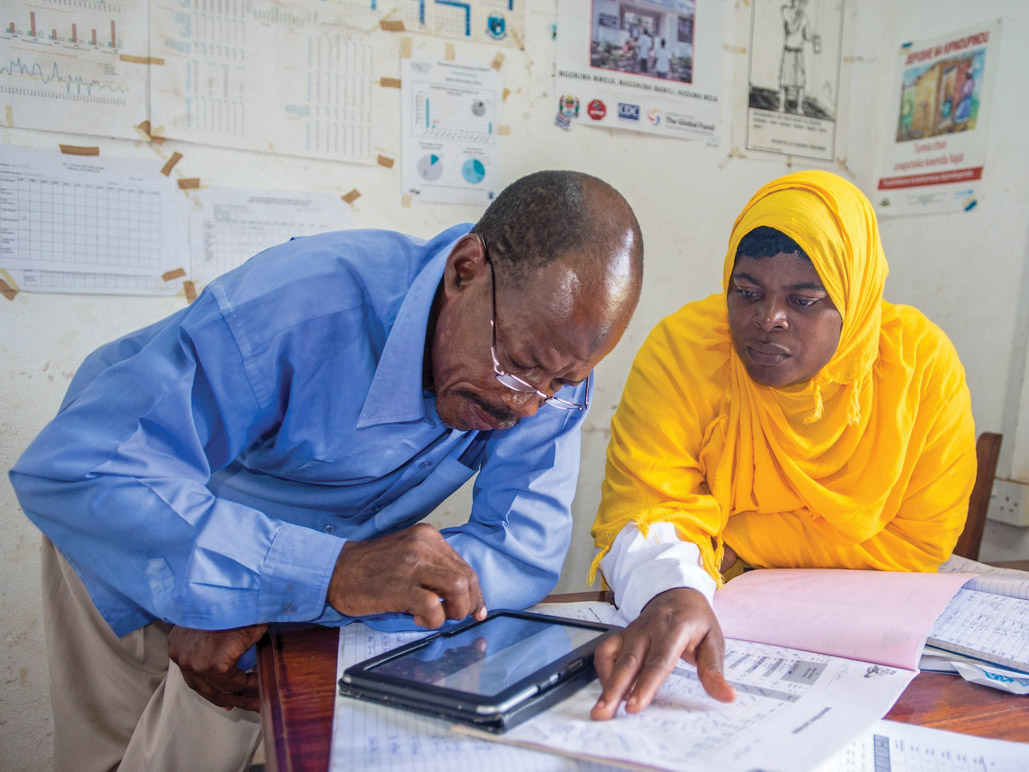 African researchers collaborate over data reports and a tablet displa