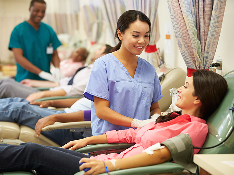 A nurse tends a woman donating blood