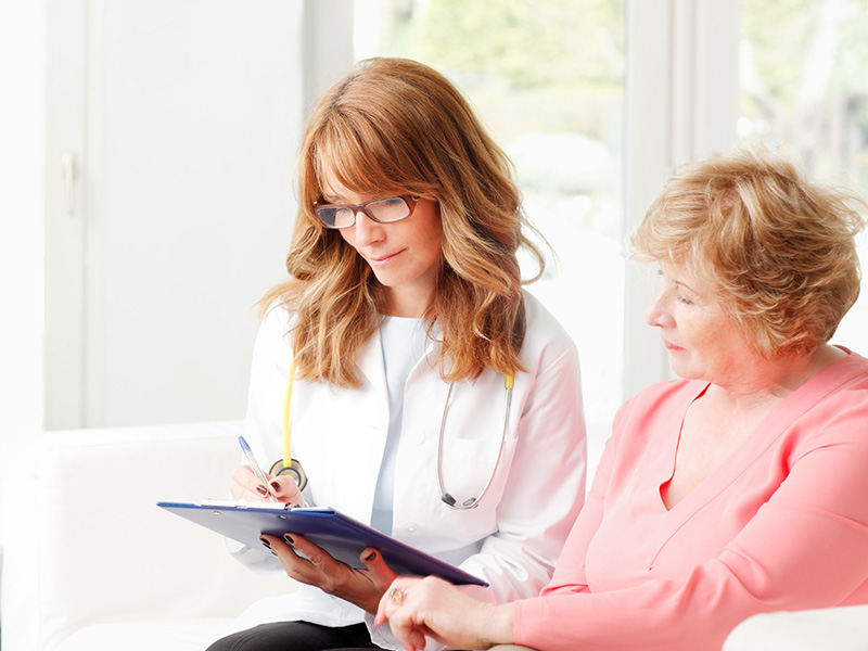 A doctor conducts an in-person survey of a patient