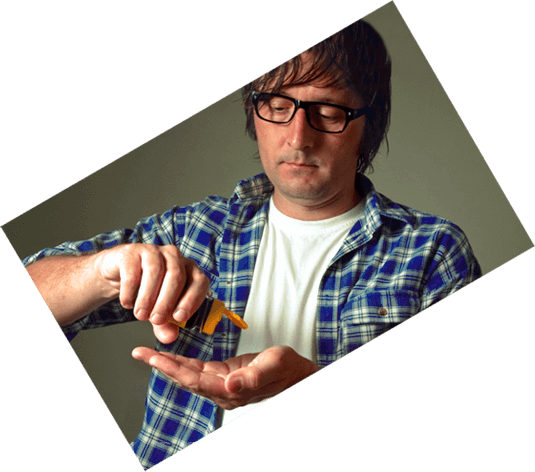 Man tipping pills from a prescription bottle out onto his palm.